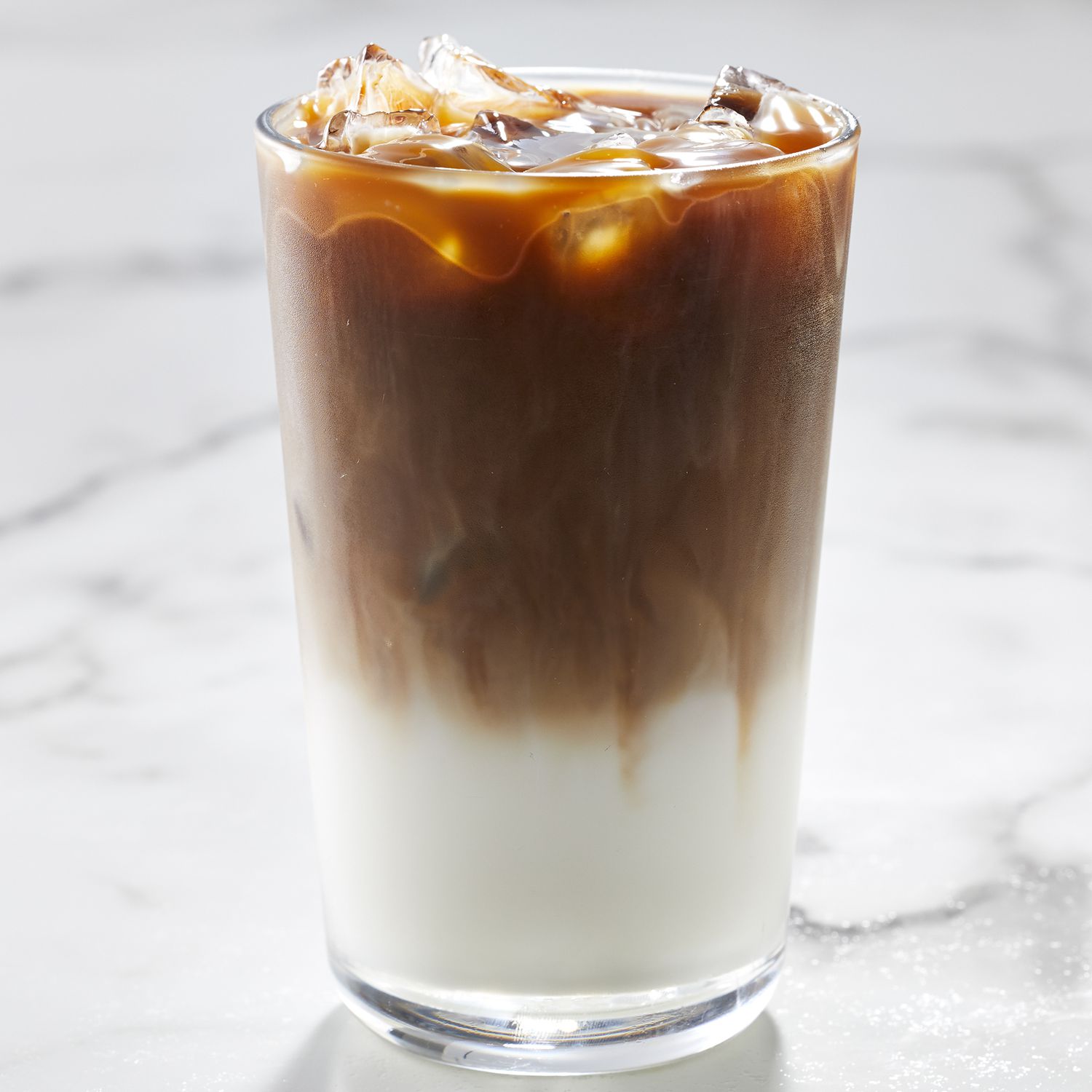 mid angle looking at an iced caramel macchiato with perfect separation