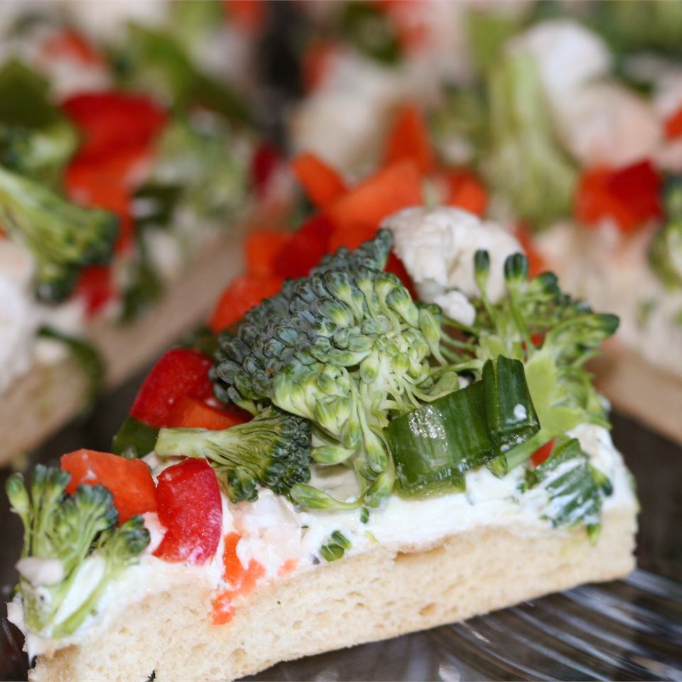 close up view of a slice of Vegetable Pizza; slice of pizza with broccoli, peppers, and green onions