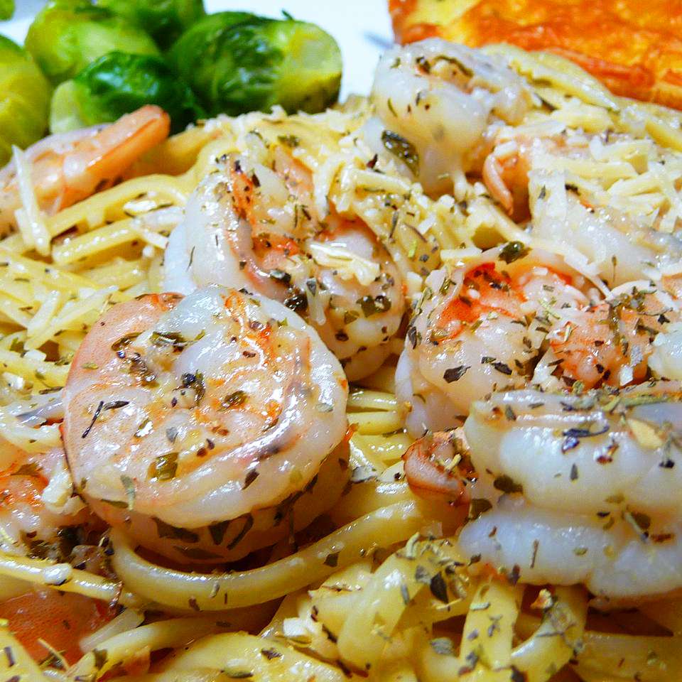 close up view of Garlic Shrimp Linguine with Brussels sprouts in the background