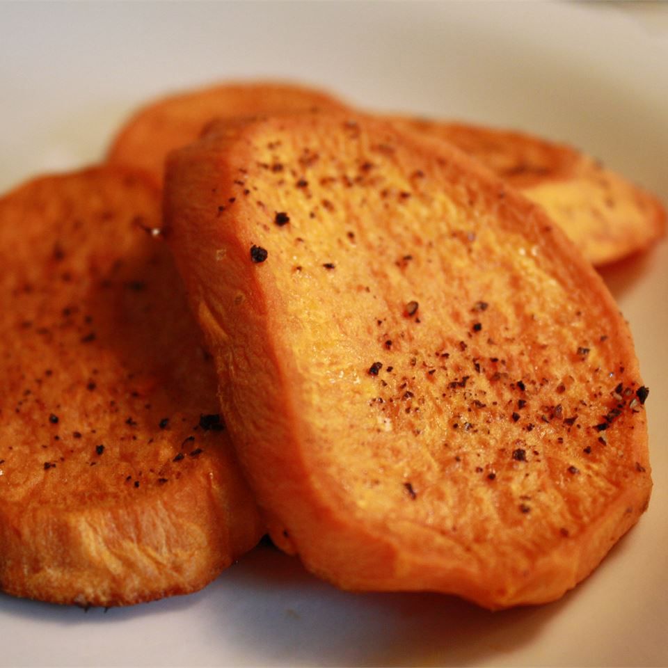 close up view of roasted yam slices in a bowl