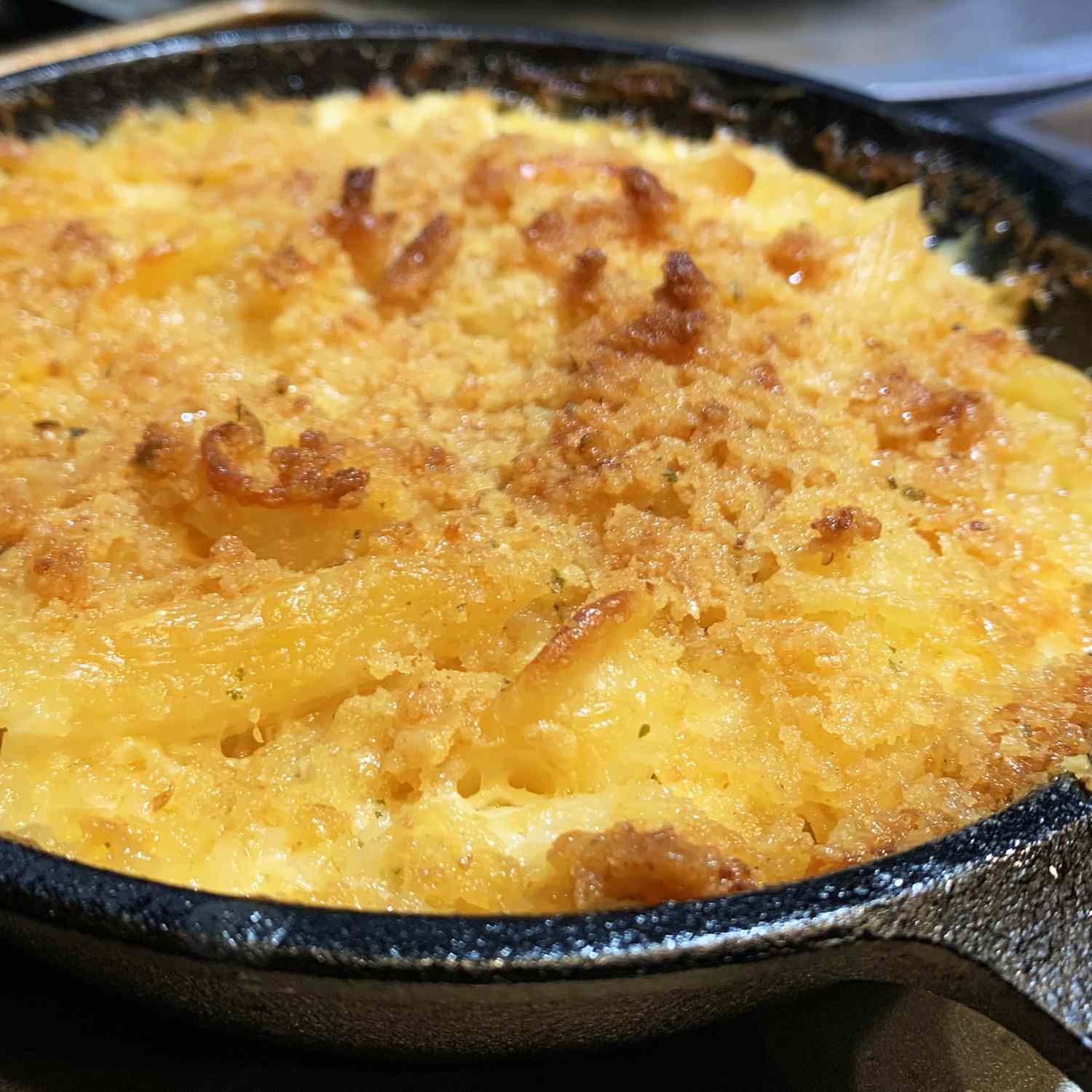 close up view of Baked Homemade Macaroni and Cheese in a small cast iron pan