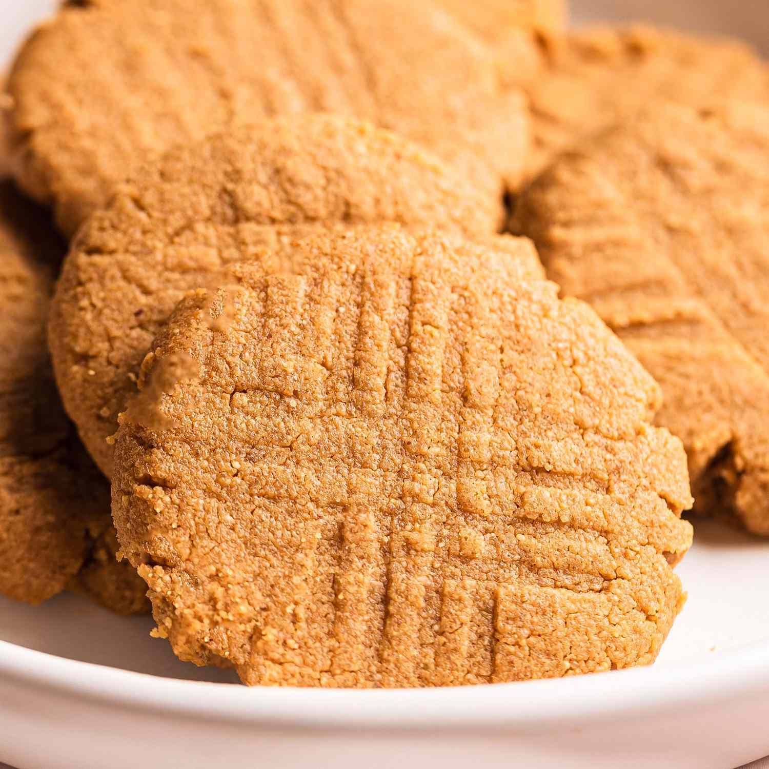 a close up view of a pile of freshly baked peanut butter cookies