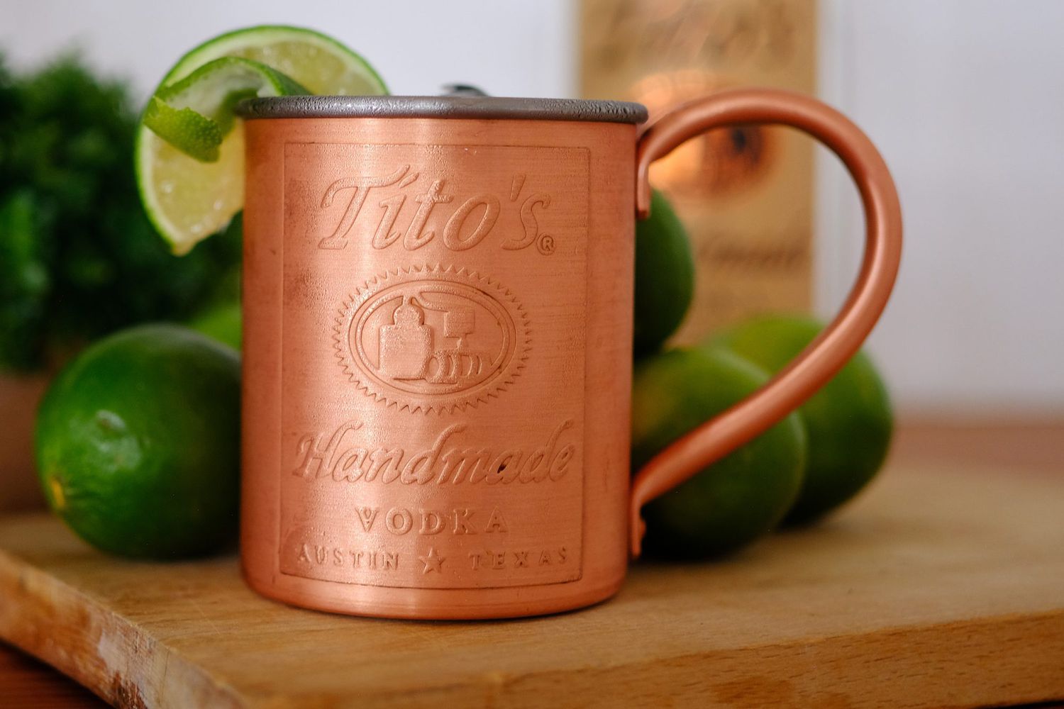 side view of a copper mug from Tito's Handmade Vodka garnished with a lime wedge
