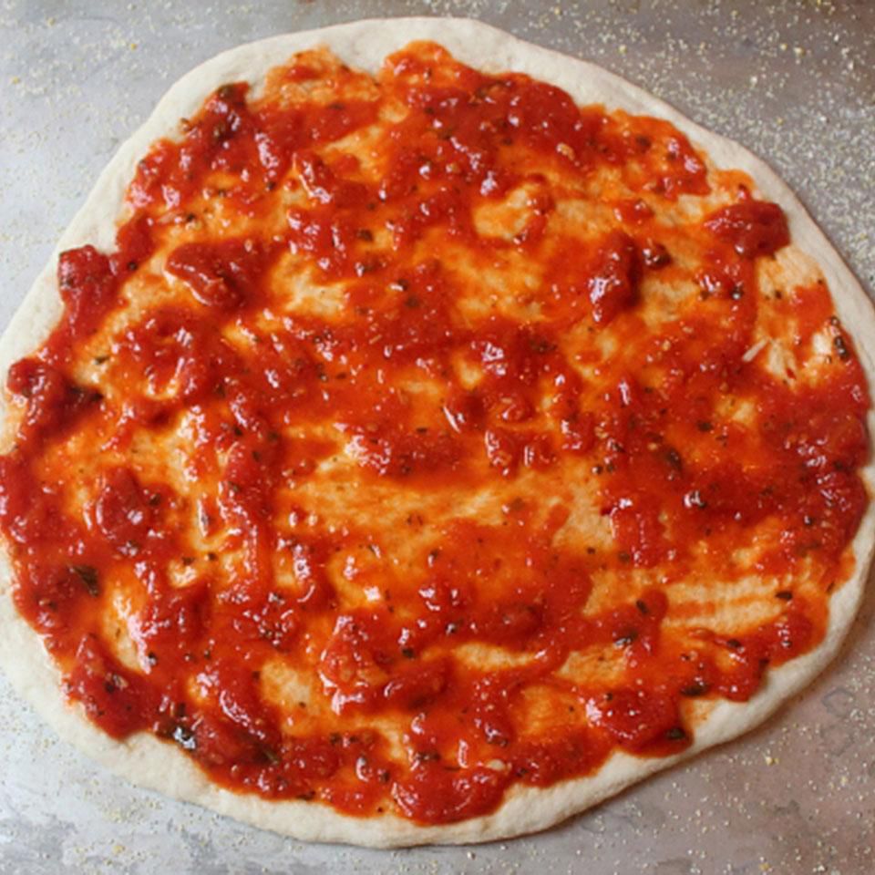close up view of pizza crust smothered with Homemade Pizza Sauce