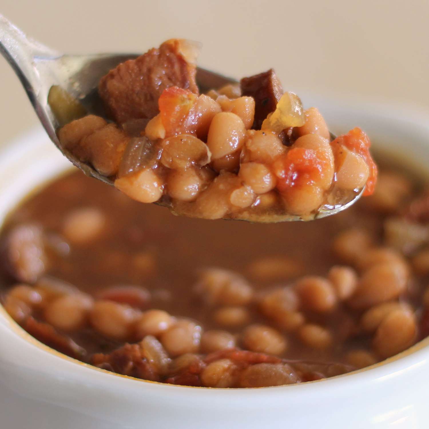 close up view of Navy Bean Soup in a bowl and on a spoon