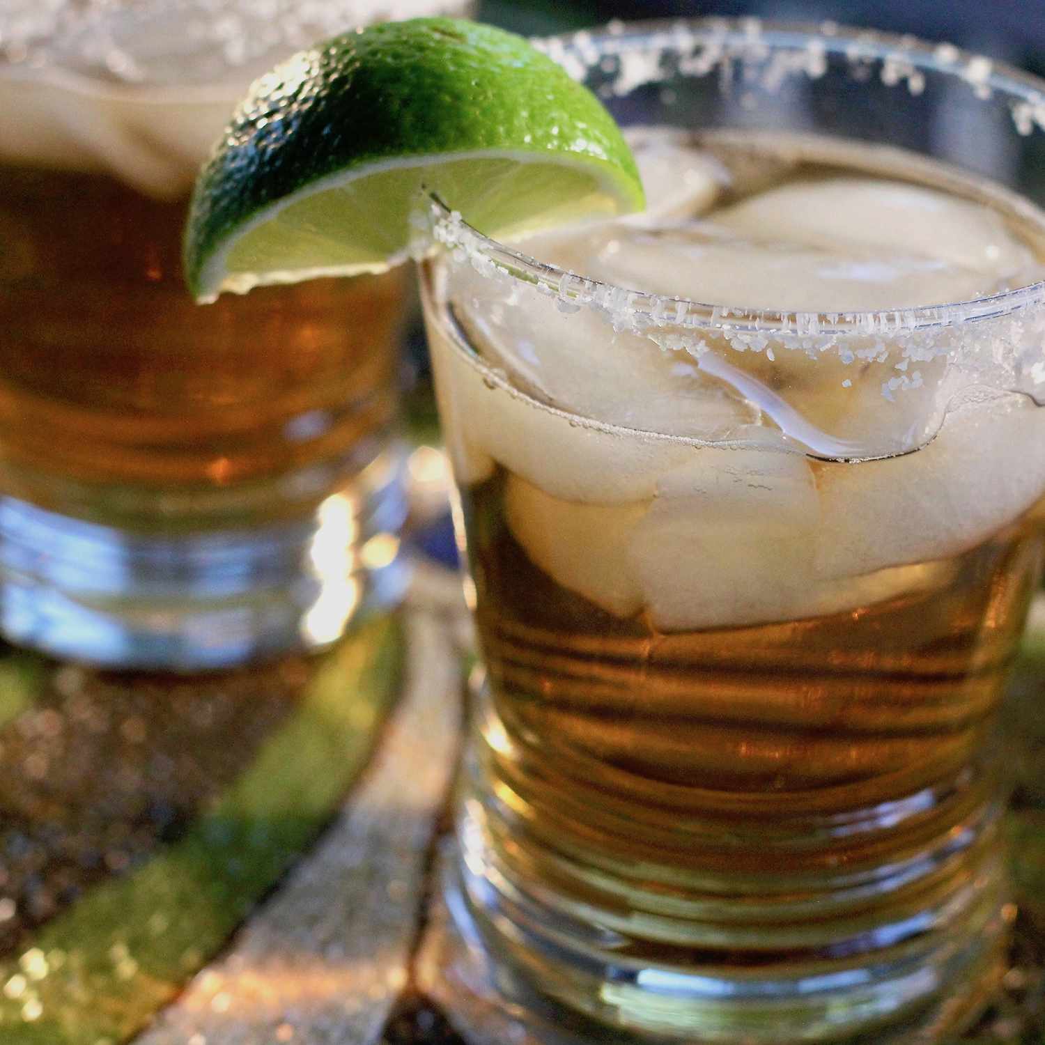 close up view of Beer Margaritas in glasses garnished with a lime wedge