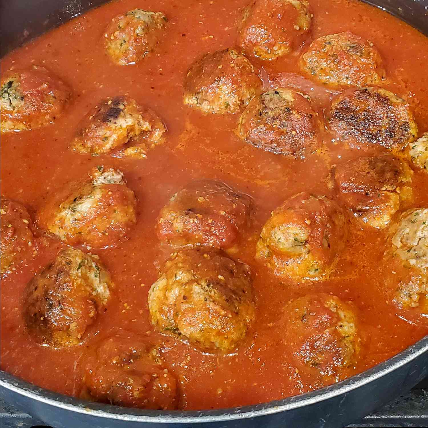 close up view of Chef John's Ricotta Meatballs in a pot