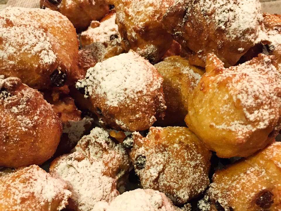 close up view of of a pile of Oliebollen (Dutch Doughnuts)