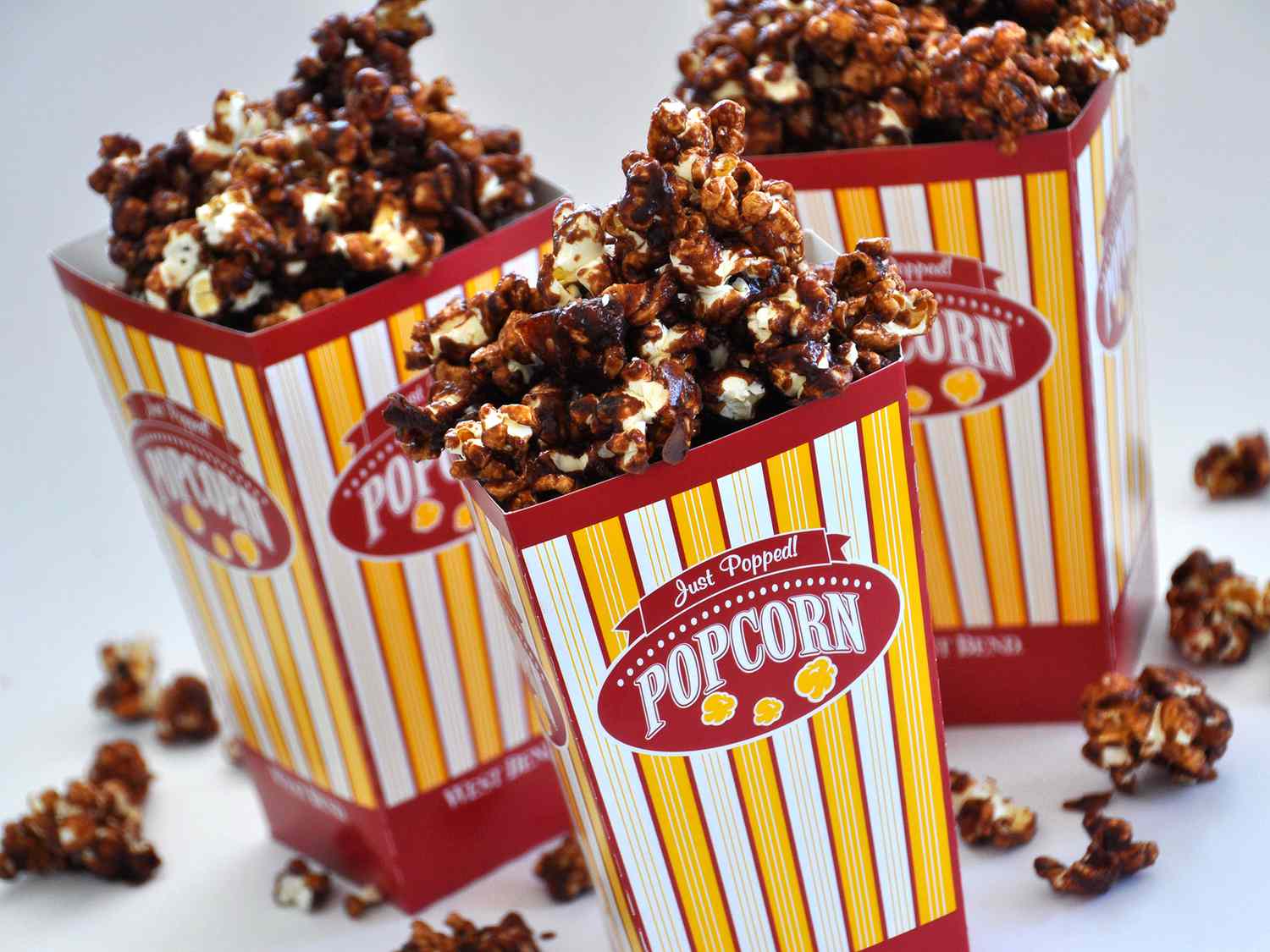 close up view of Chocolate Popcorn in colorful popcorn containers