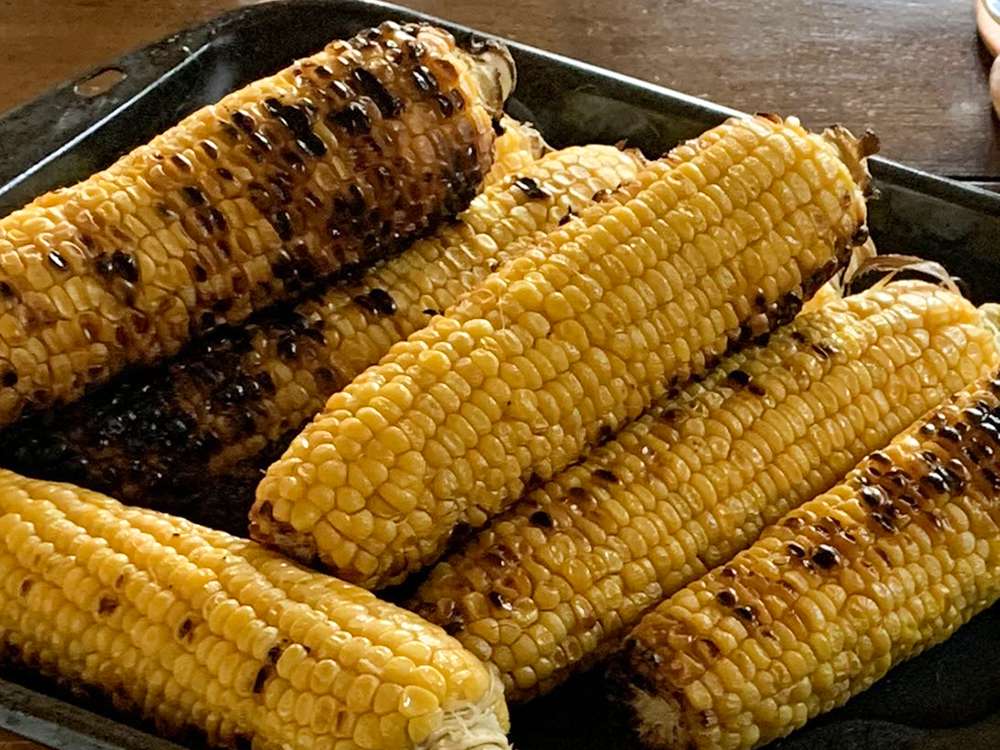 close up view of Grilled Corn On The Cob in a baking dish