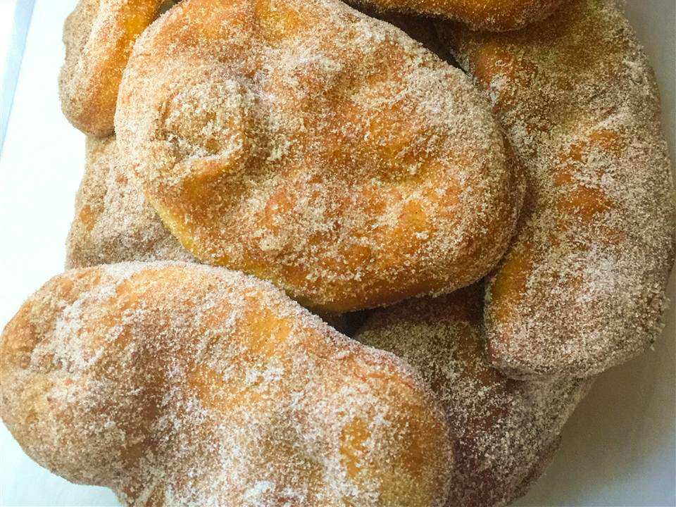 close up view of a pile of Canadian Fried Dough on a platter