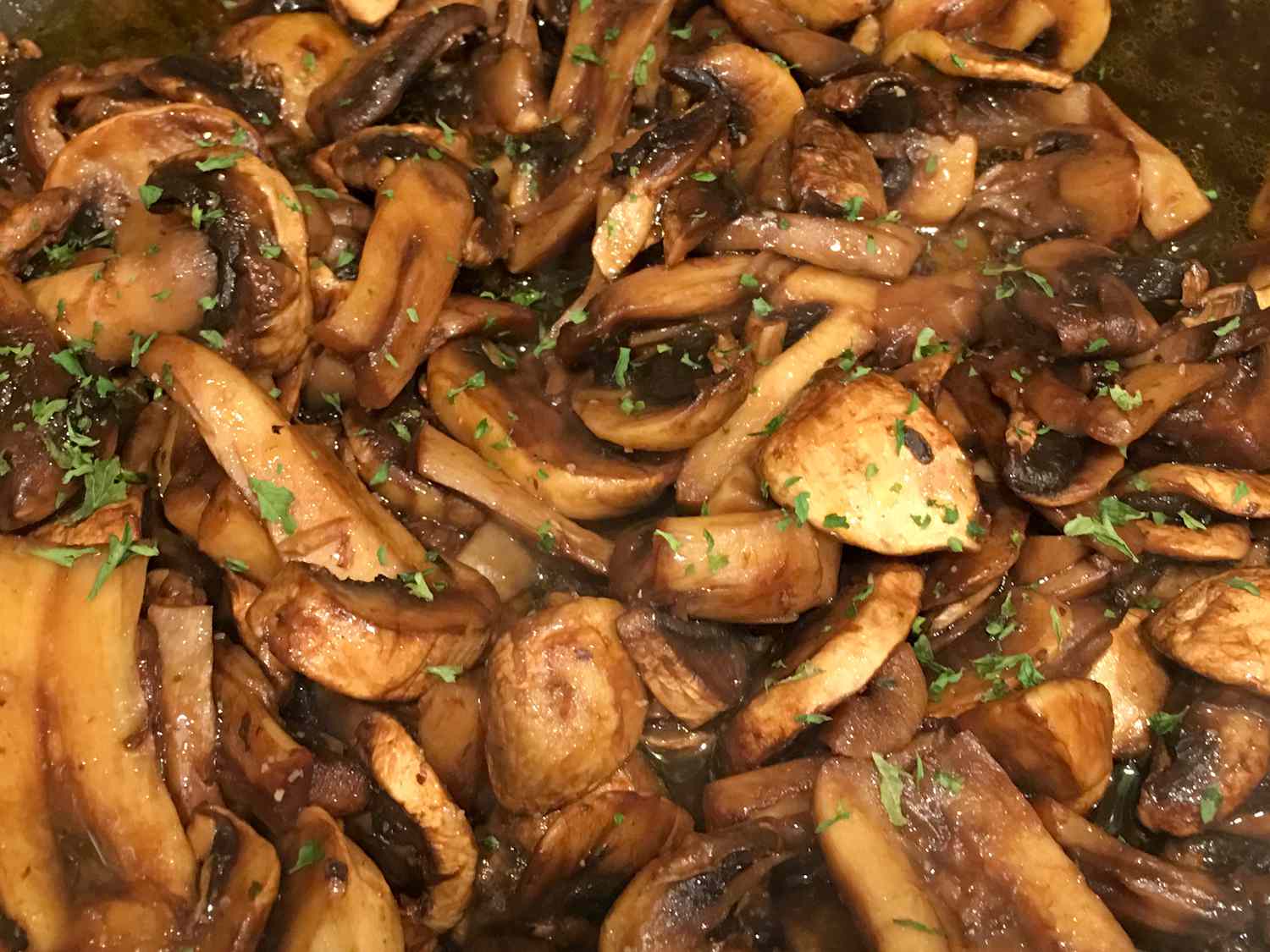 close up view of Balsamic Mushrooms with fresh herbs