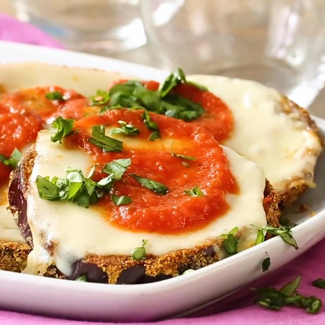 a close up view of air fryer eggplant parmesan served on a platter