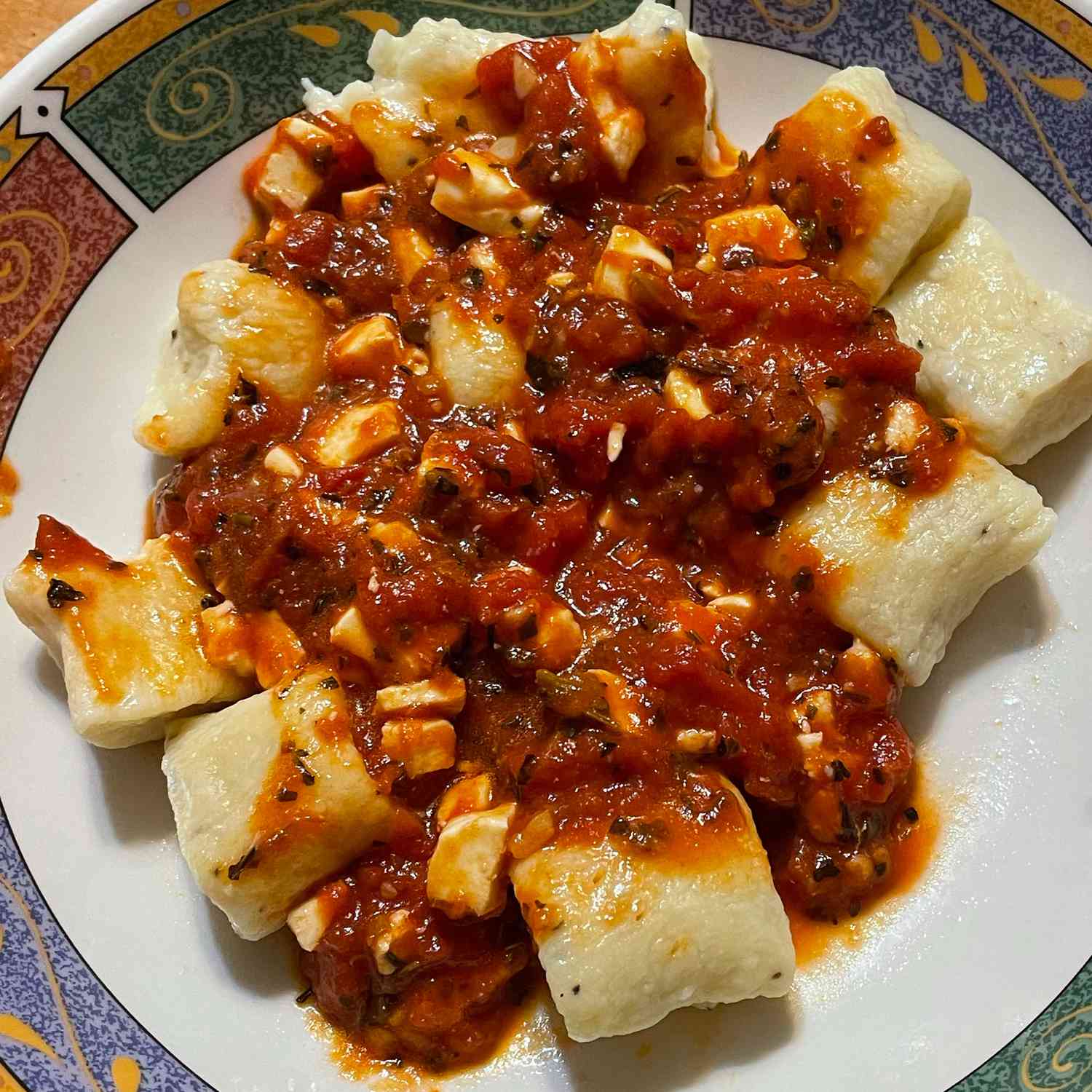 close up view of Ricotta Gnocchi with red sauce on a plate