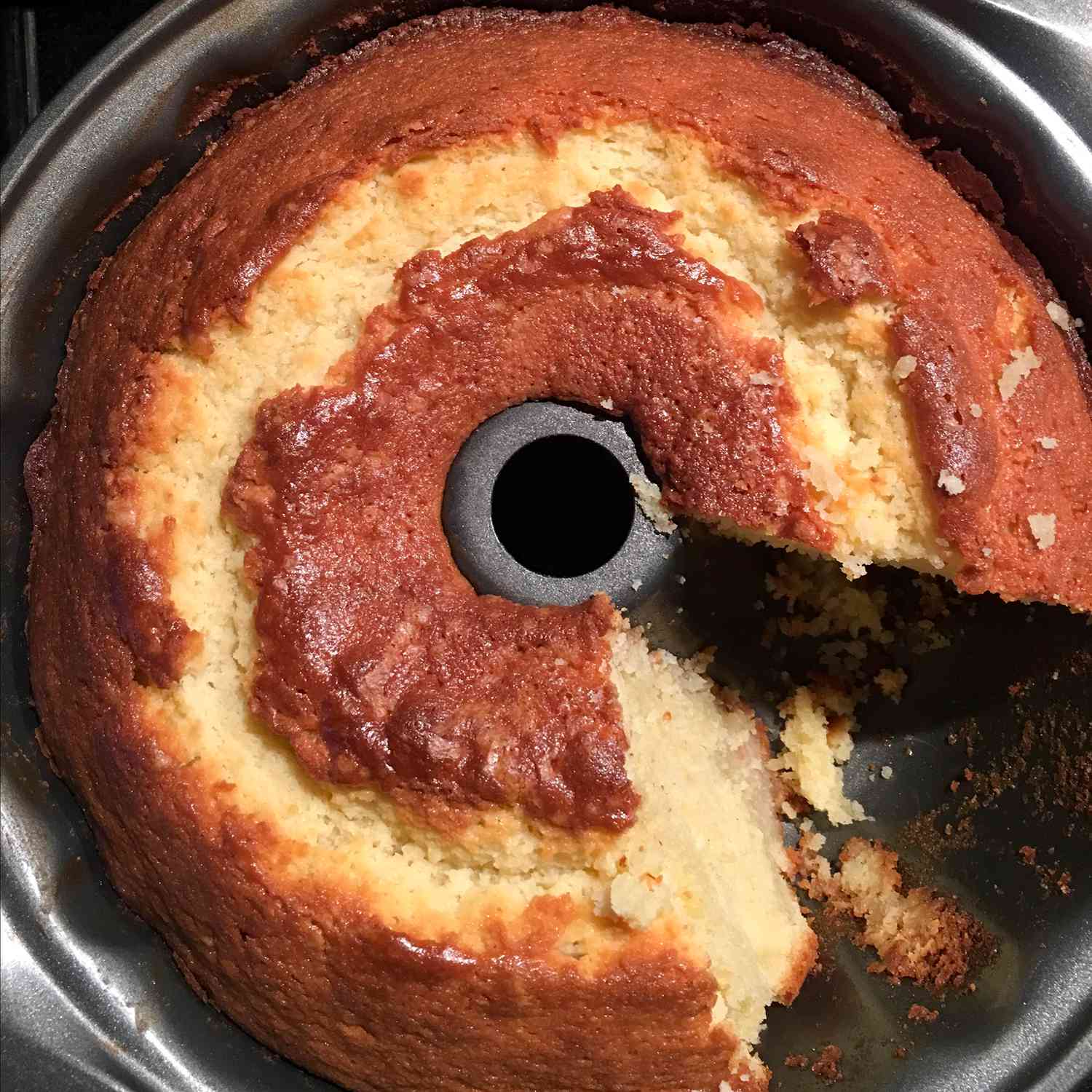 close up view of Sour Cream Pound Cake with a slice missing in a bundt pan