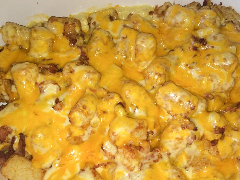 close up view of Loaded Tater Tots in a white baking dish