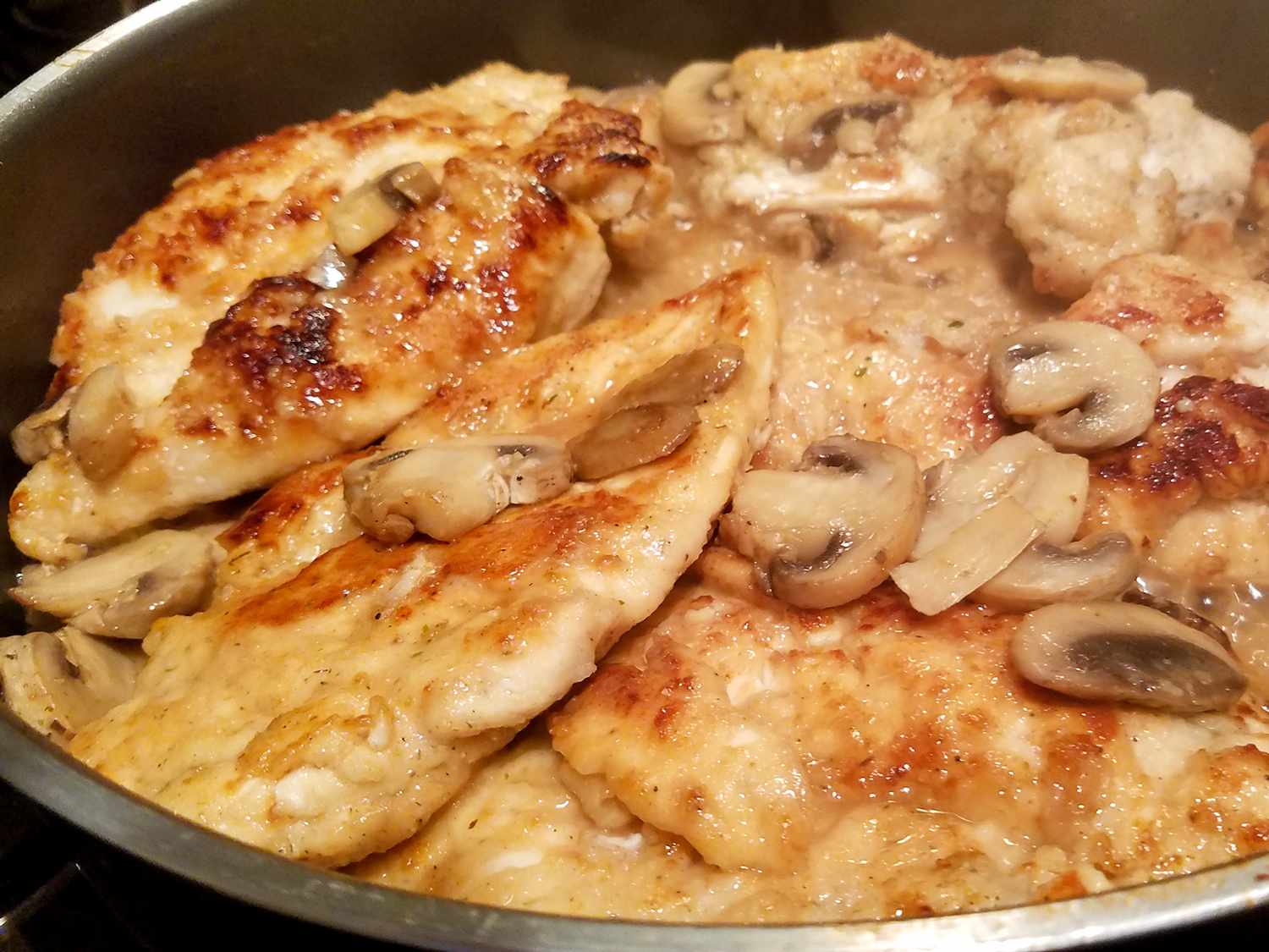 close up view of Chicken Marsala with mushrooms in a pan