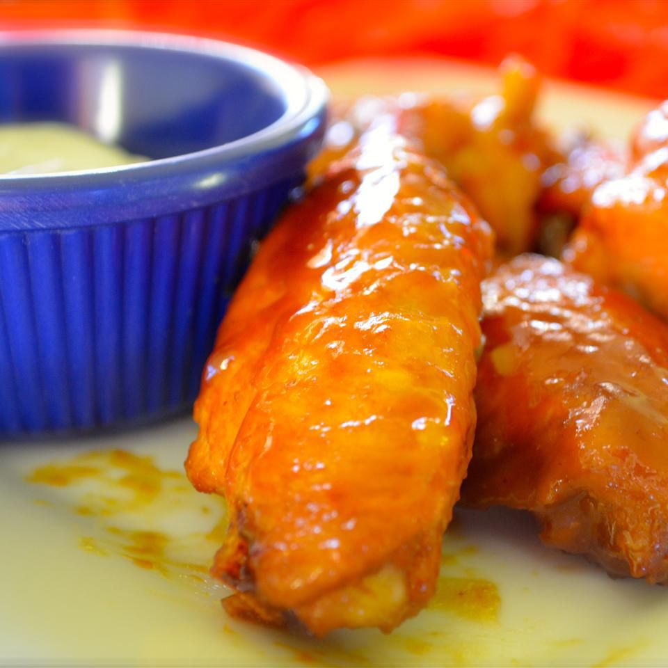 close up view of Chicken Wings and sauce in a bowl