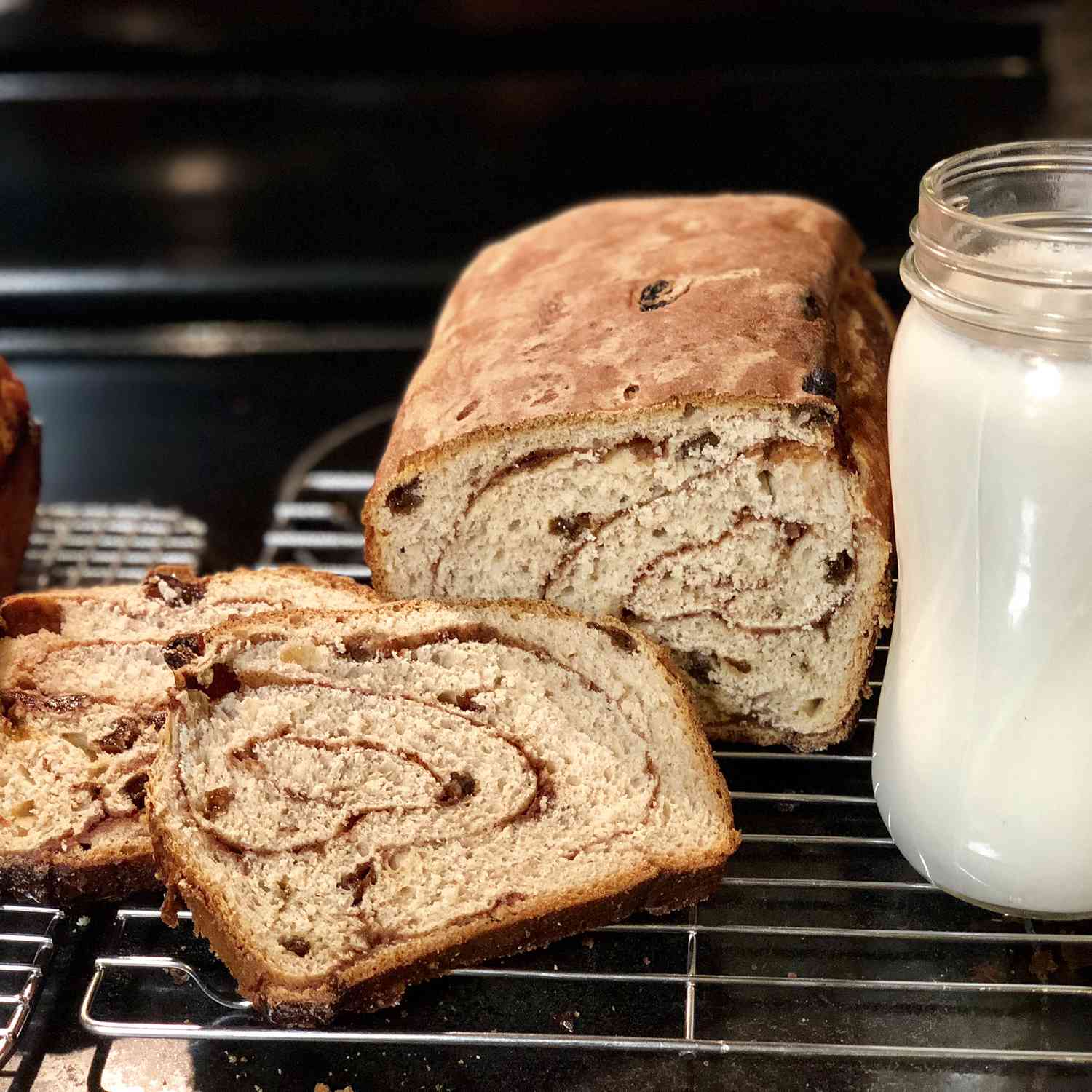 close up view of sliced Cinnamon Raisin Bread on a cooling rack