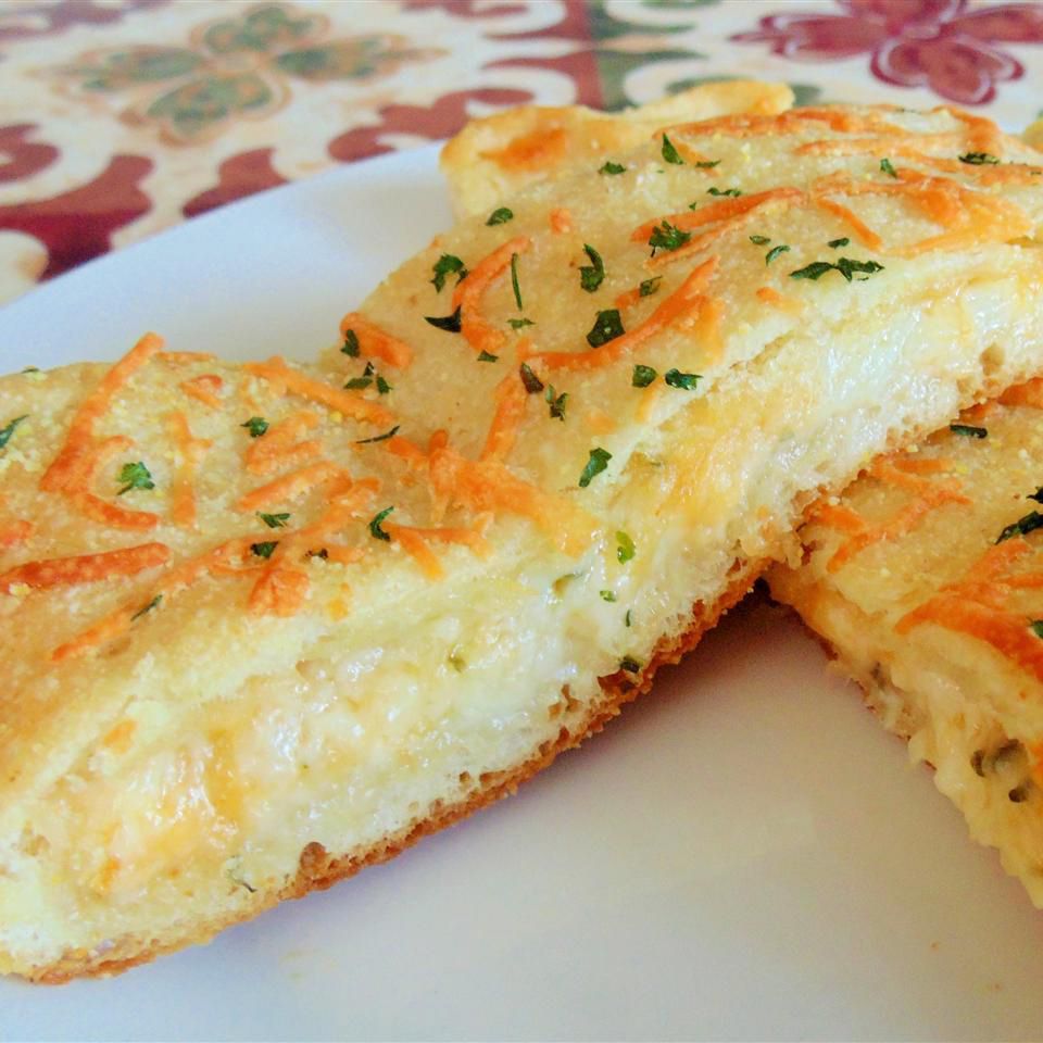 close up view of Cheesy Stuffed Bread slices on a white plate