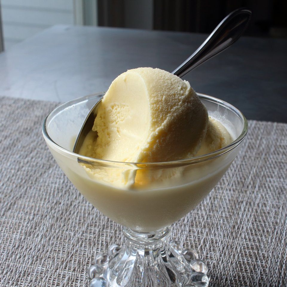 close up view of Frozen Vanilla Custard in a glass ice cream bowl with a spoon
