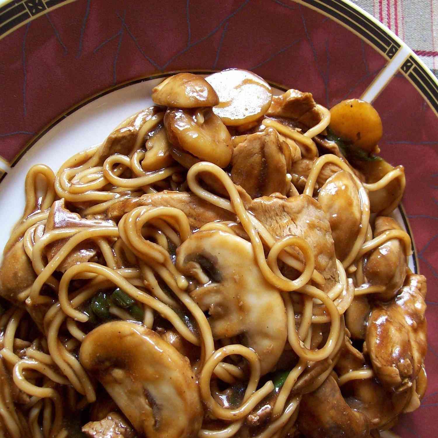 close up view of Chicken Lo Mein with mushrooms in a bowl