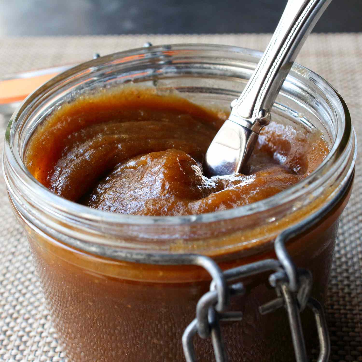 close up view of Apple Butter in a jar with a butter knife