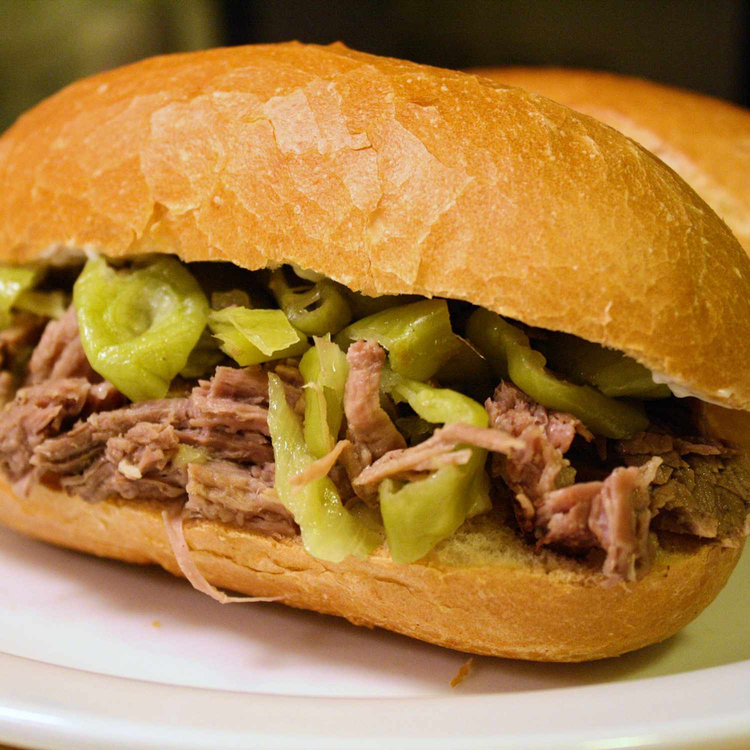 side view of shredded beef sandwiches with pepperoncini