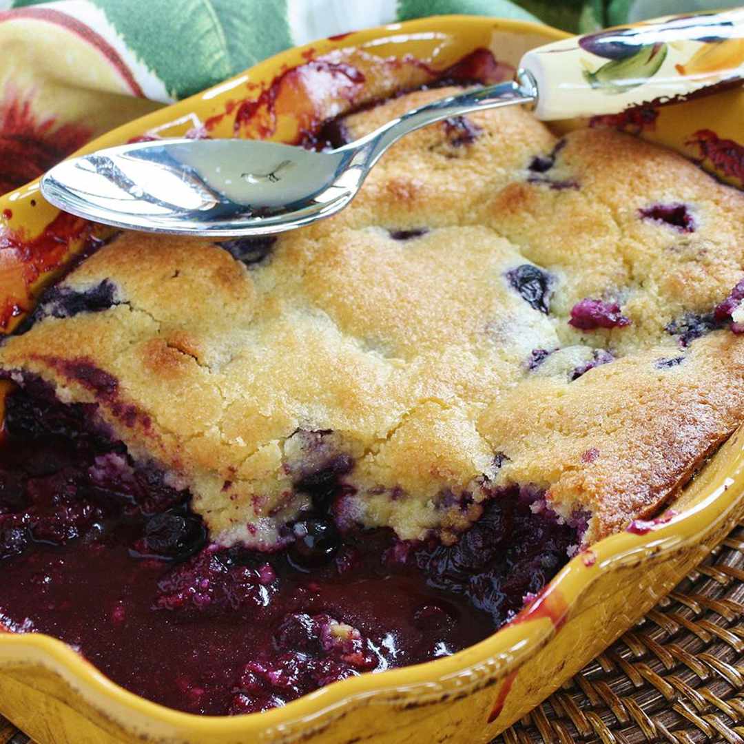blueberry cobbler in yellow baking dish
