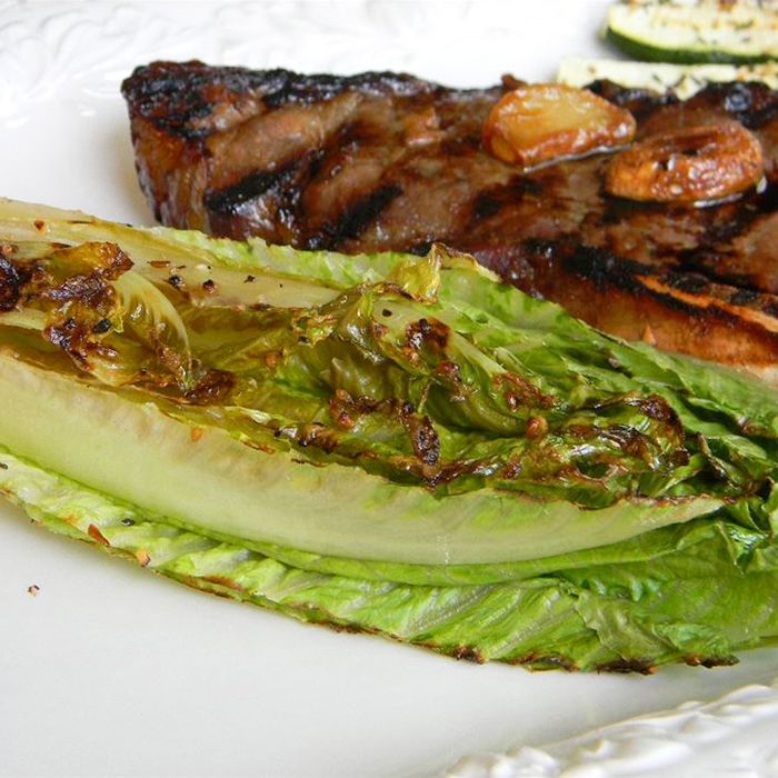 close up view of Grilled Romaine on a white plate with grilled steak