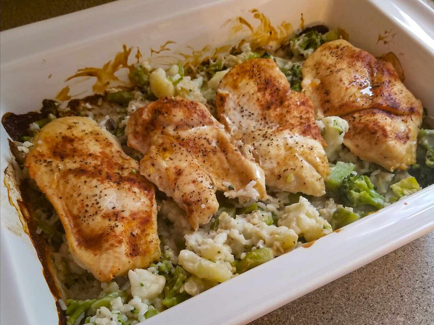 close up view of a Chicken and Rice Bake in a white baking dish