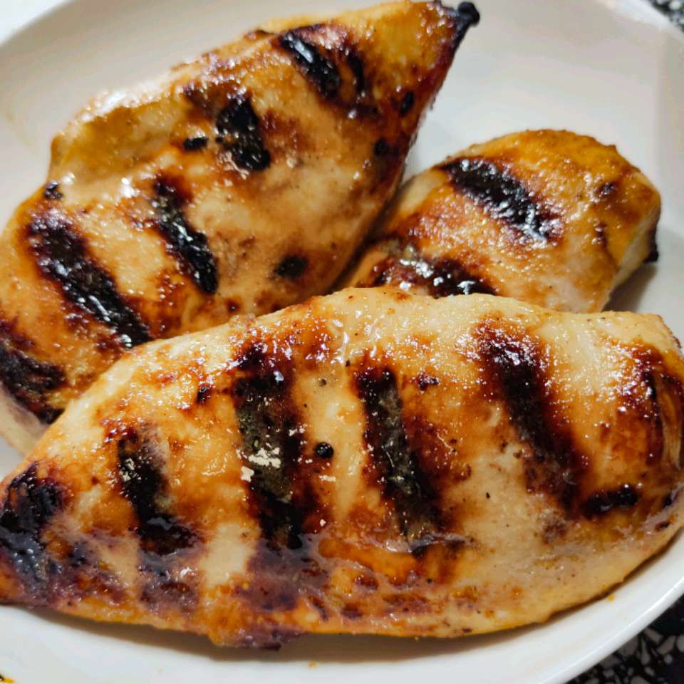 close up view of grilled chicken fillets in a white bowl