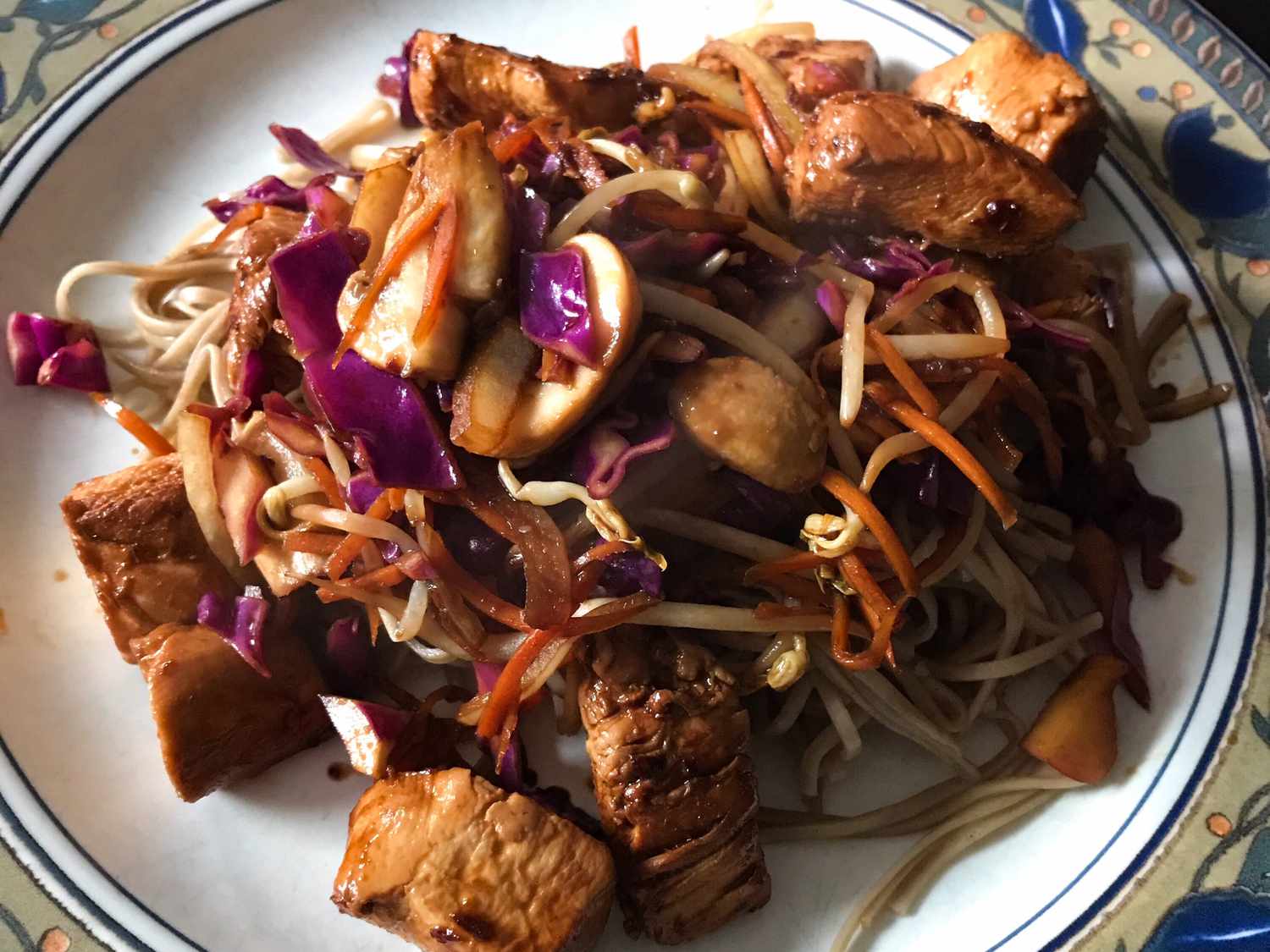 close up view of Yakisoba Chicken with noodles, cabbage and carrots on a plate