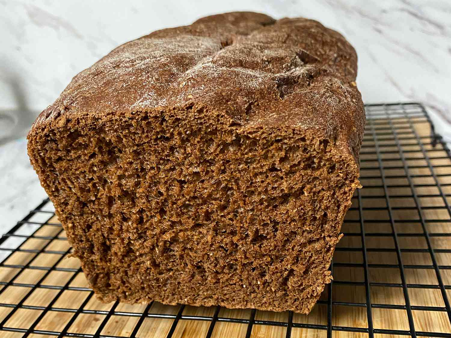 close up view of Bread Machine Pumpernickel Bread on a cooling rack