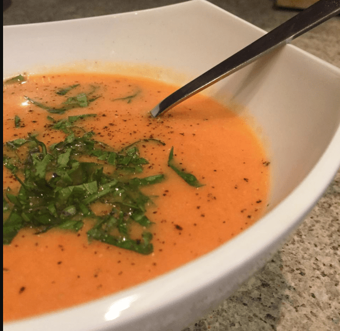 tomato soup with basil and parsleyin it