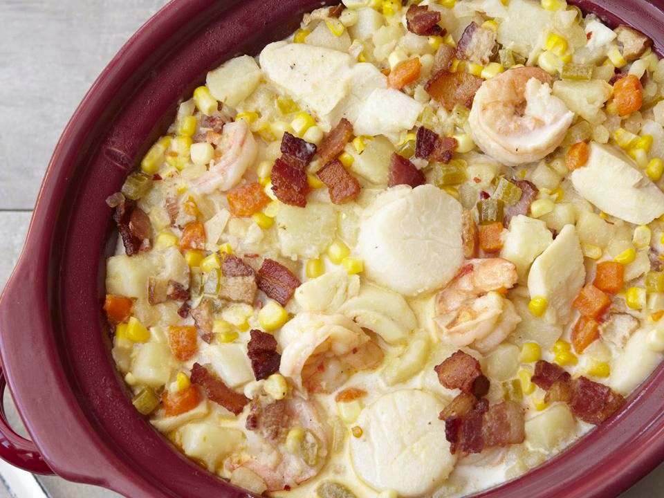 close up view of Slow-Cooker Fish Chowder in a maroon slow cooker