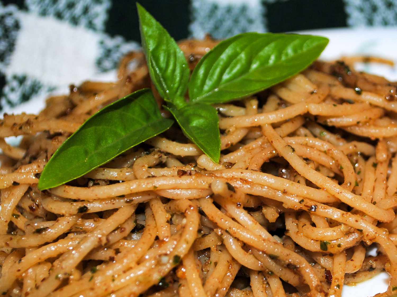 close up view of Simple Pesto Pasta garnished fresh basil