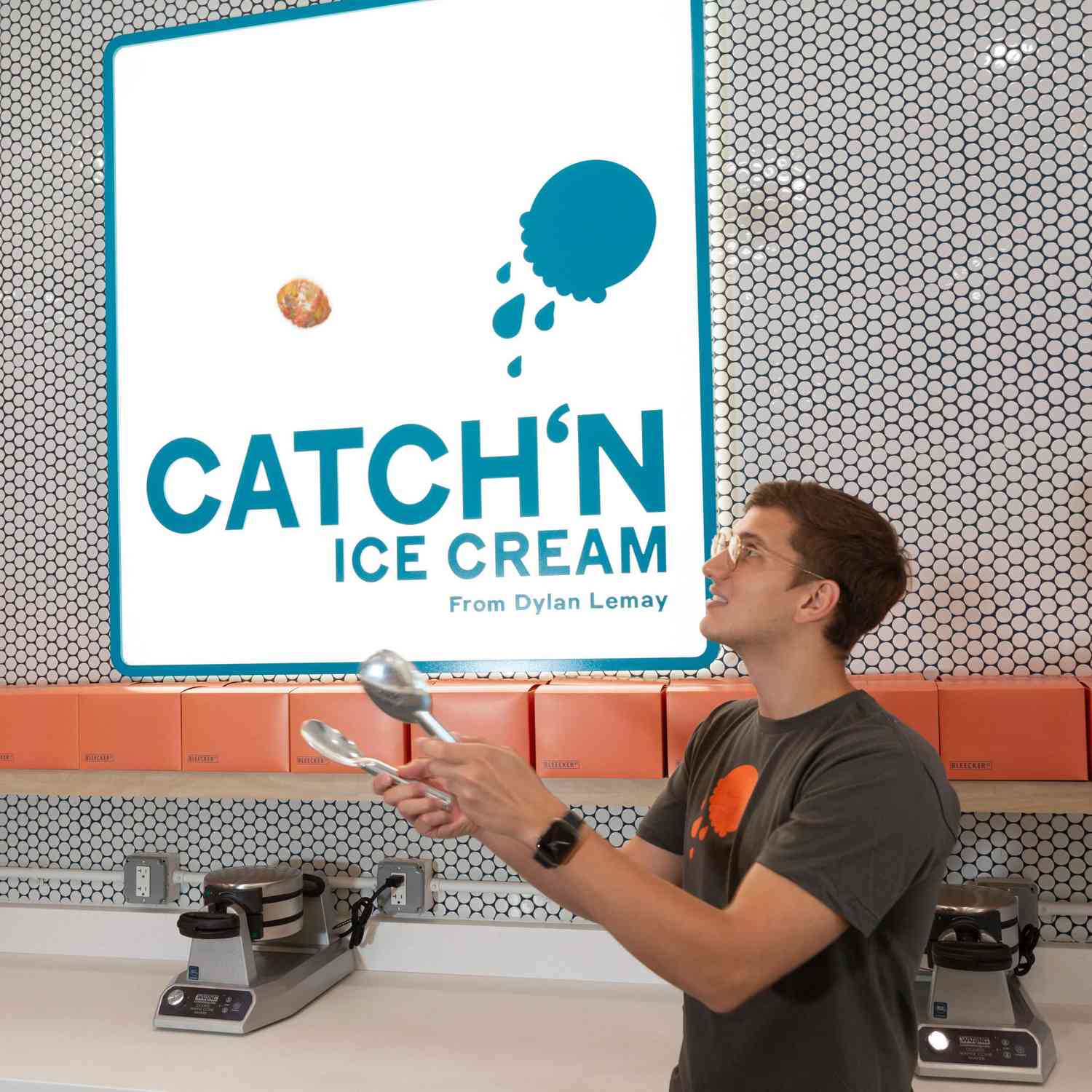 TikTok Creator Dylan Lemay carries a tray of ice cream balls in his NYC shop Catch'n Ice Cream