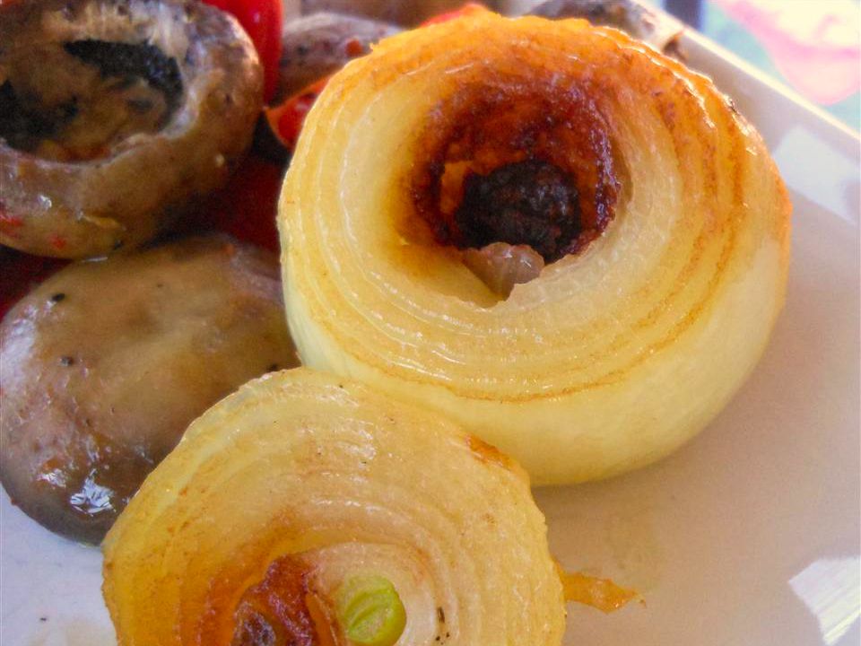 close up view of Grilled Onions and mushrooms on a plate