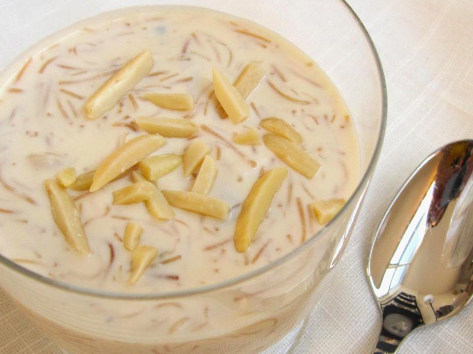 close up view of Vermicelli Pudding in a glass bowl with a spoon on the side