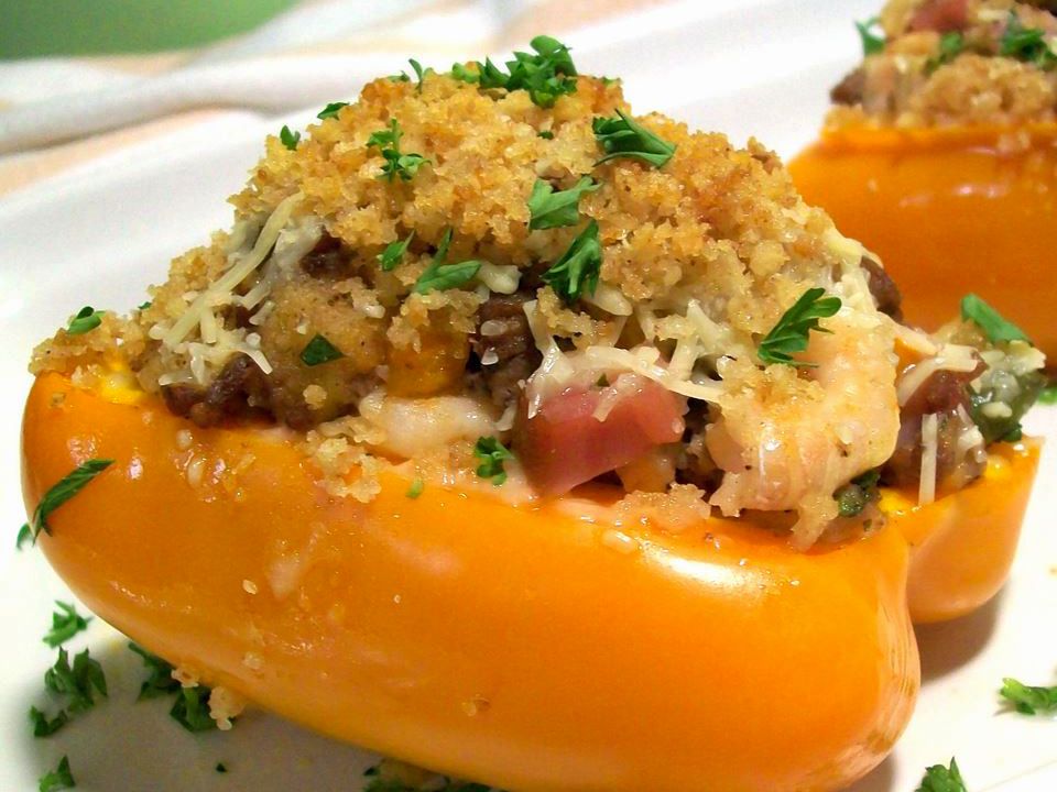 close up view of Stuffed Bell Peppers garnished with fresh herbs on a white plate