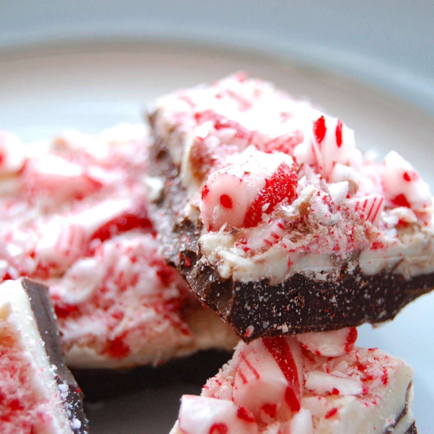 close up view of a pile of Peppermint Bark pieces on a plate