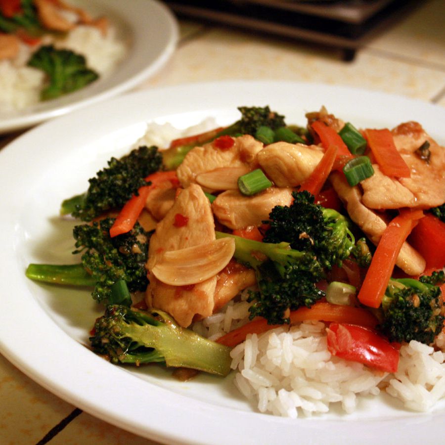 close up view of Sweet and Spicy Stir Fry with Chicken and Broccoli on white plates
