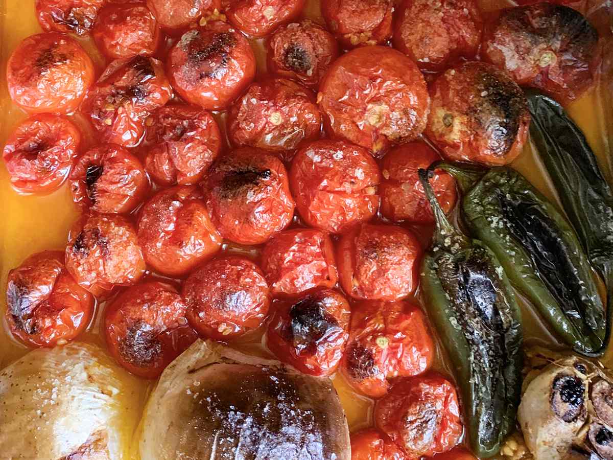 Roasted Tomatoes with Garlic and jalapeños on a baking sheet