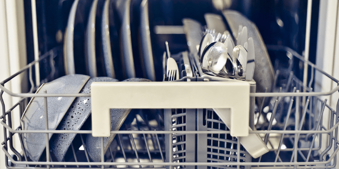 Clean dishes and cutlery in a dishwasher.