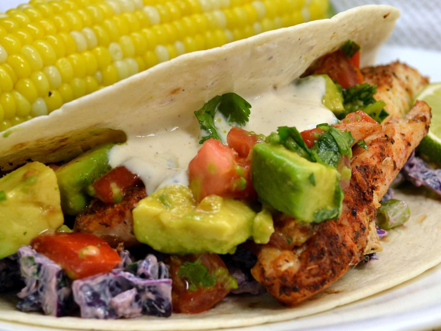 close up view of a Fish Taco served with corn