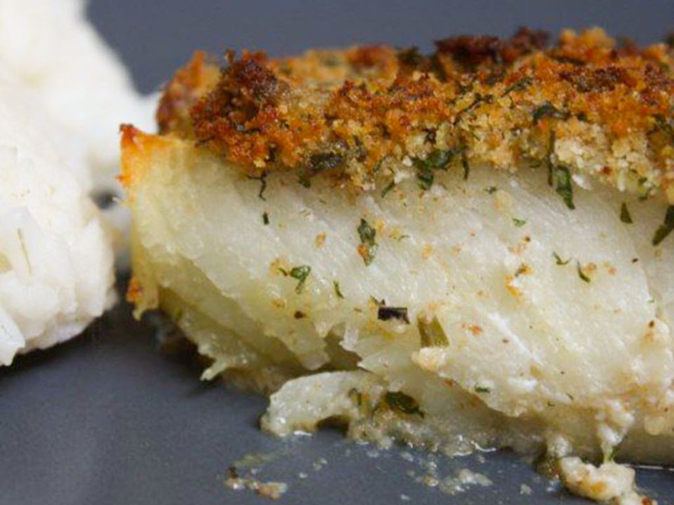 close up view of a fillet of Oven-Baked Cod with Bread Crumbs served with white rice