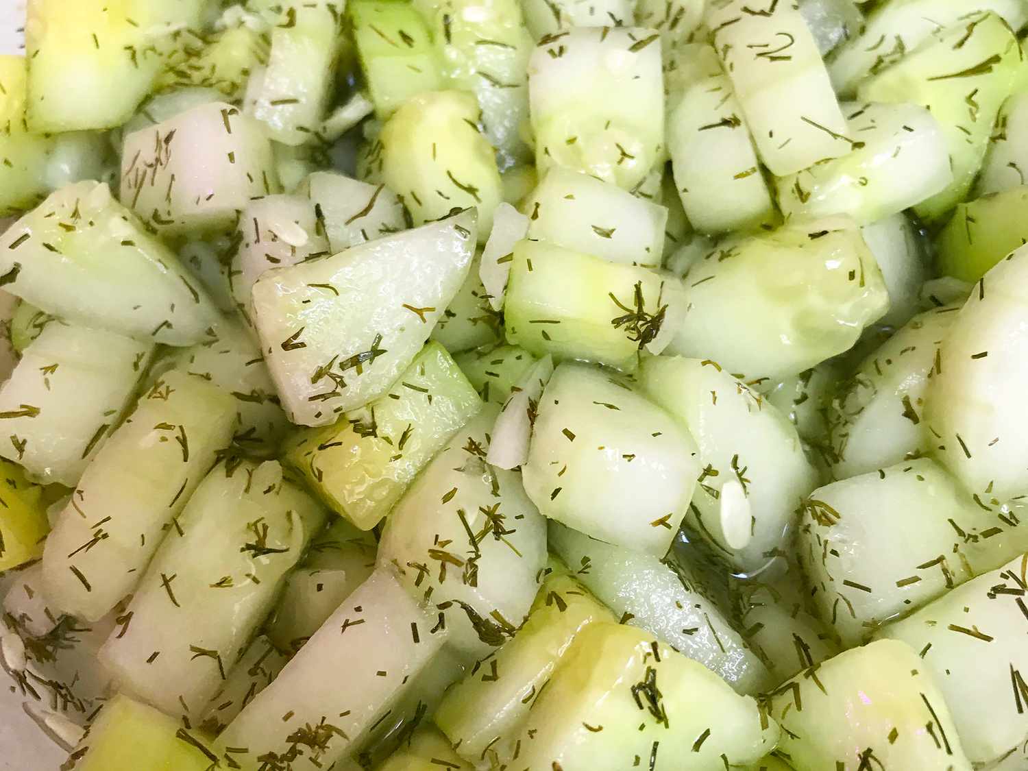 close up view of Easy Cucumber Salad with fresh herbs