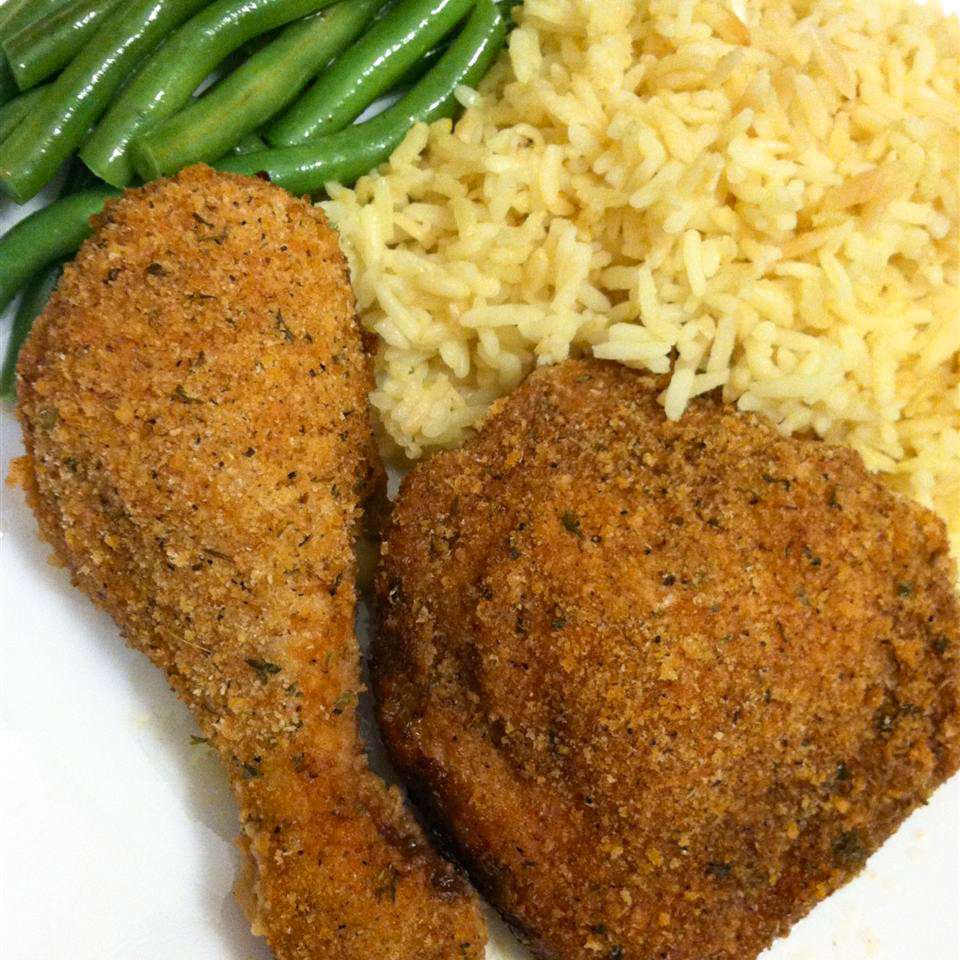 close up view of Fried Chicken served with rice and green beans on a plate