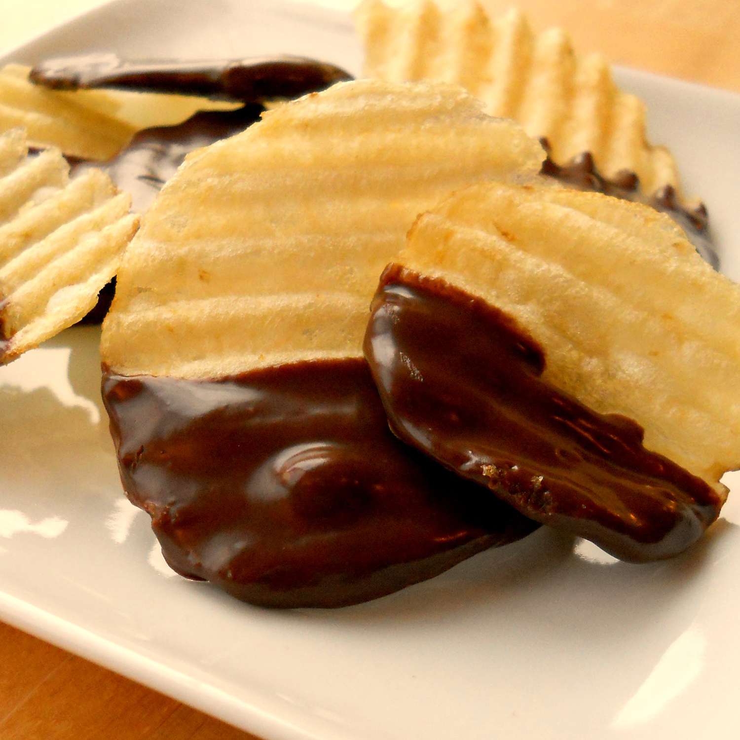 close up view of Chocolate Covered Potato Chips on a white plate